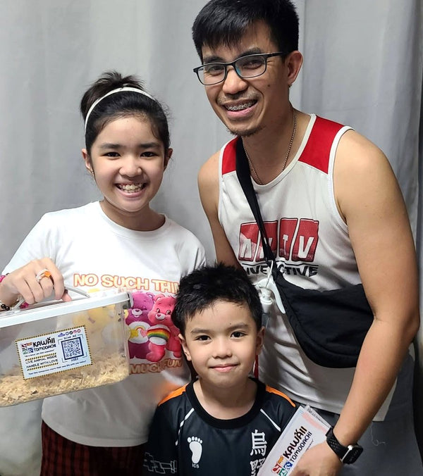 A family holding their new hamster in our carrier